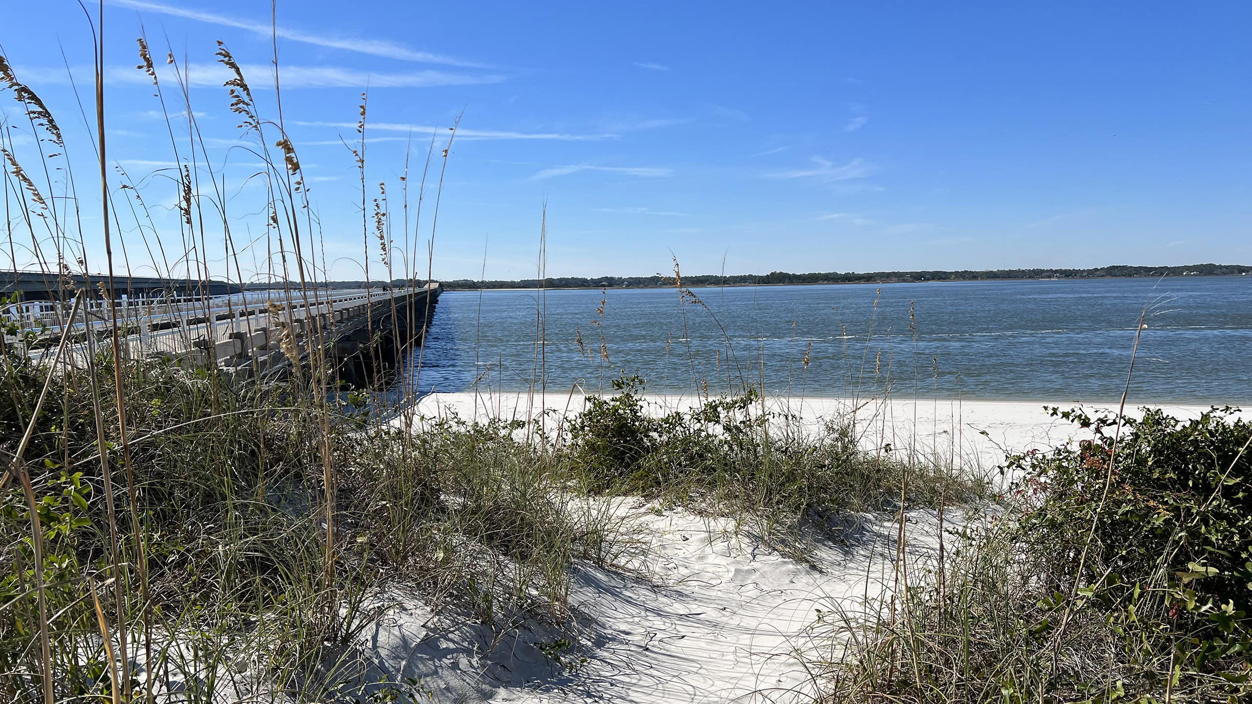 Old bridge adjoining sparkling white sand beach