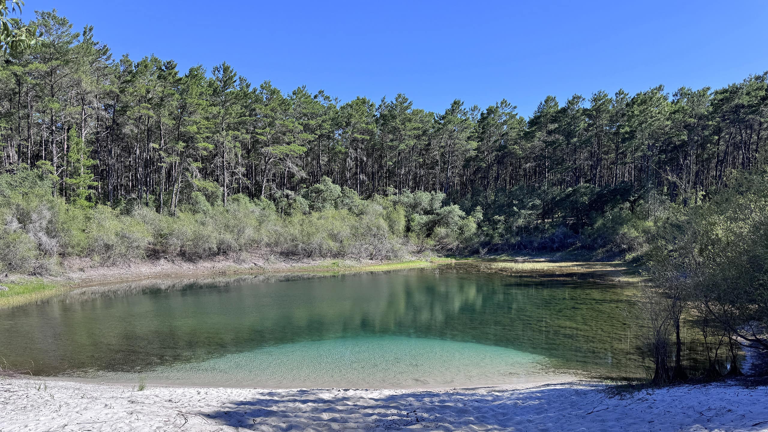 Pond with white sand and aquamarine water